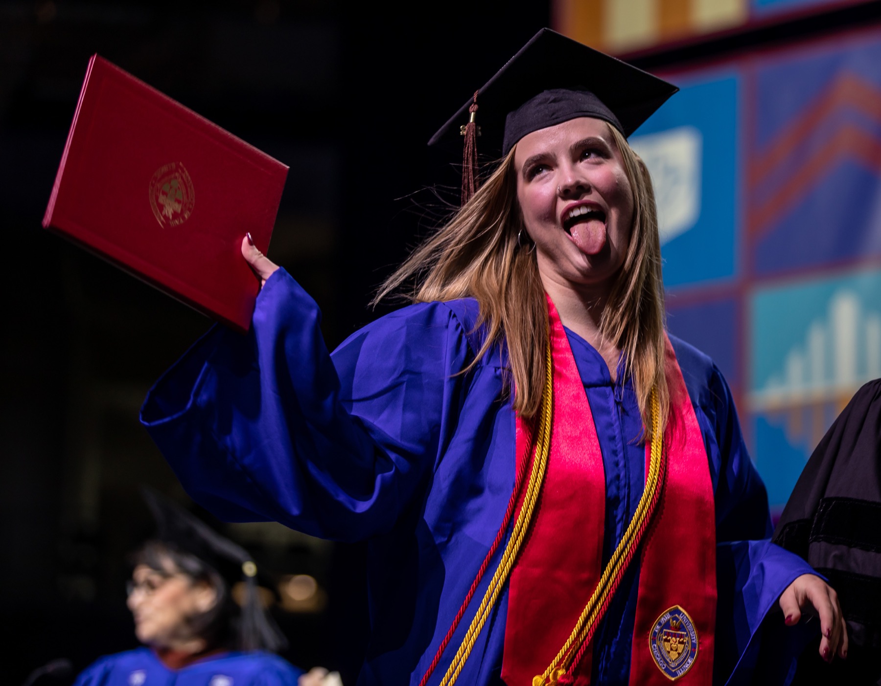 A graduate showed off one of the many emotions of relief and accomplishment after accepting her diploma.